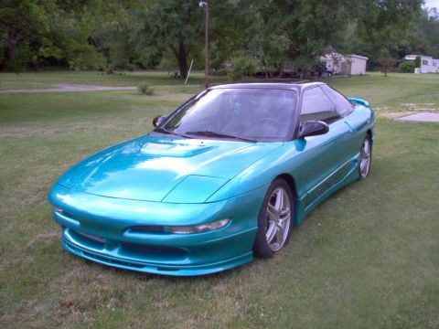 1993 Ford Probe - Teal 1993 Ford Probe with a black roof and custom body kit sits on a grassy lawn.