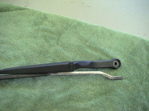1997 Ford Probe - Close-up of a car's windshield wiper arm and blade assembly.