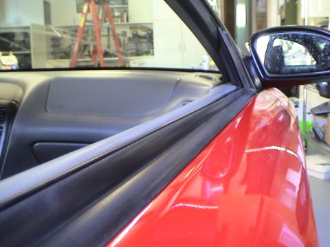 1997 Ford Probe - Interior view of a car's door frame and dashboard, showing part of the side mirror.