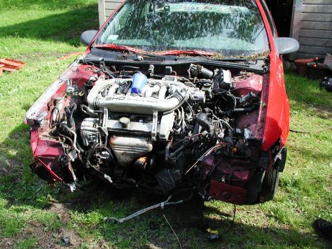1992 Ford Taurus - Front view of a damaged 1992 Ford Taurus, showing the SHO 3.0L 24-valve V6 engine.