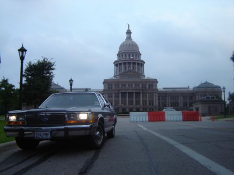1988 Ford Crown Victoria LTD - 1988 Ford Crown Victoria parked in front of a capitol building under a cloudy sky.