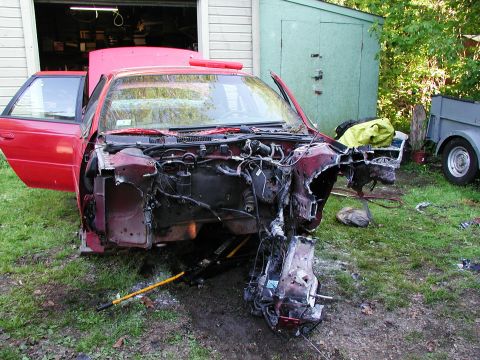 1992 Ford Taurus - This car is heavily damaged at the front and appears to be undergoing disassembly or repair.