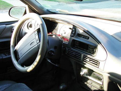 1992 Ford Taurus - The interior of a 1992 Ford Taurus shows the steering wheel, dashboard, and center console.