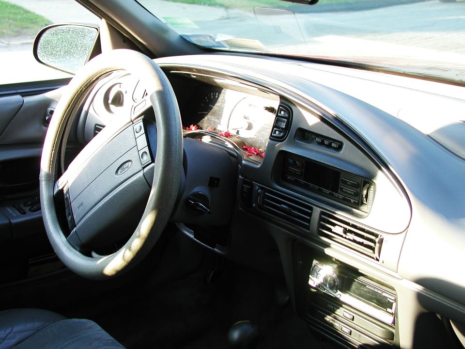 1992 Ford Taurus interior with a gray steering wheel, dashboard, and radio