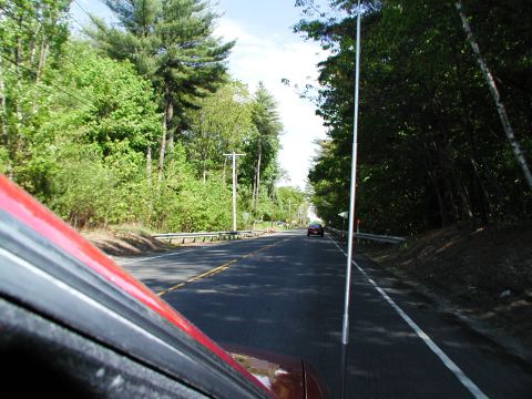 1992 Ford Taurus - Driving down a tree-lined road with a single car ahead.