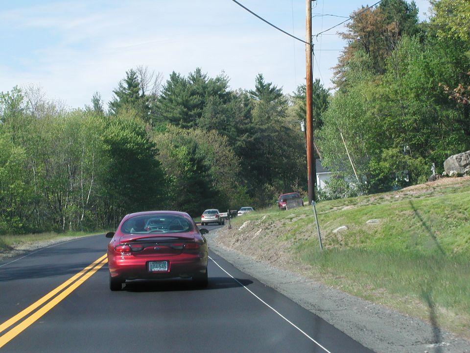Red 1992 Ford Taurus rear view on a road