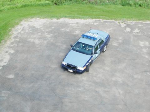 1992 Ford Taurus - A police car with "STATE POLICE" text on the door is viewed from an aerial perspective.