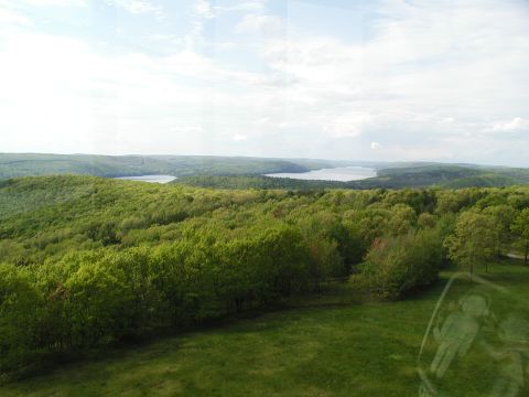 1992 Ford Taurus - Expansive view of rolling green hills and distant lakes on a partly cloudy day.