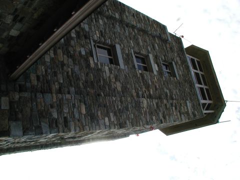 1992 Ford Taurus - The exterior of a building constructed with irregular stone blocks, several windows and a modern glassed section.