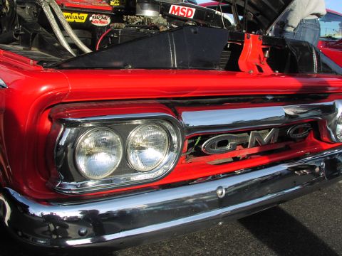 1979 Ford Bronco - Front view of a red GMC truck with its hood open, revealing the engine and MSD ignition components.