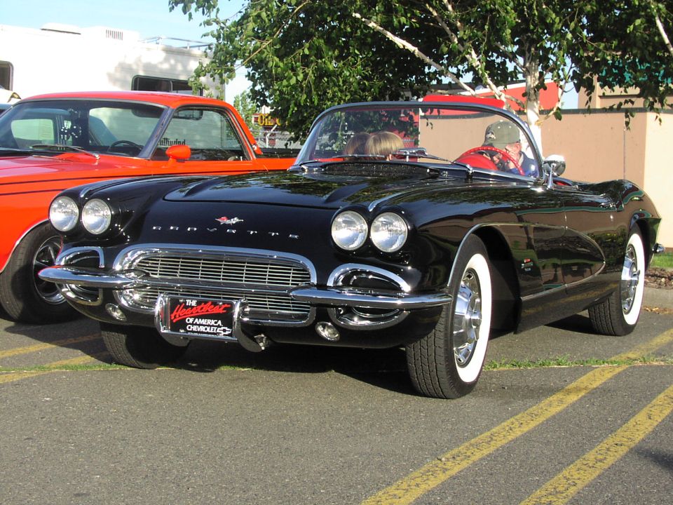 Black 1959 Corvette convertible with whitewall tires and a Chevrolet badge