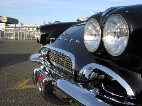 1979 Ford Bronco - Front view of a classic black 1957 Chevrolet Bel Air, highlighting its iconic grille and headlights.