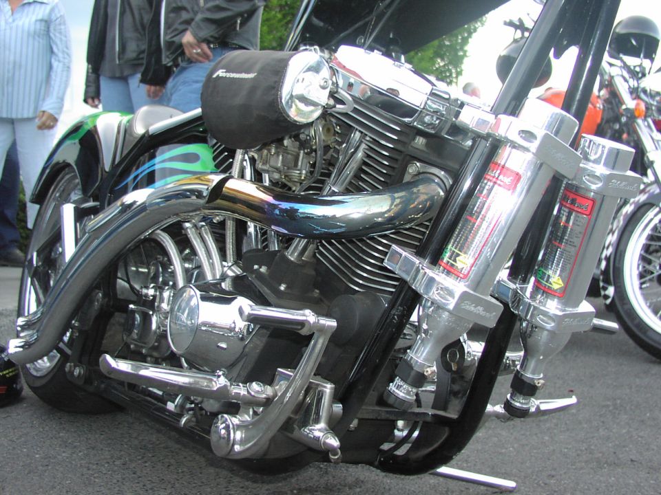 Motorcycle engine with chrome exhaust and green flames on the fender