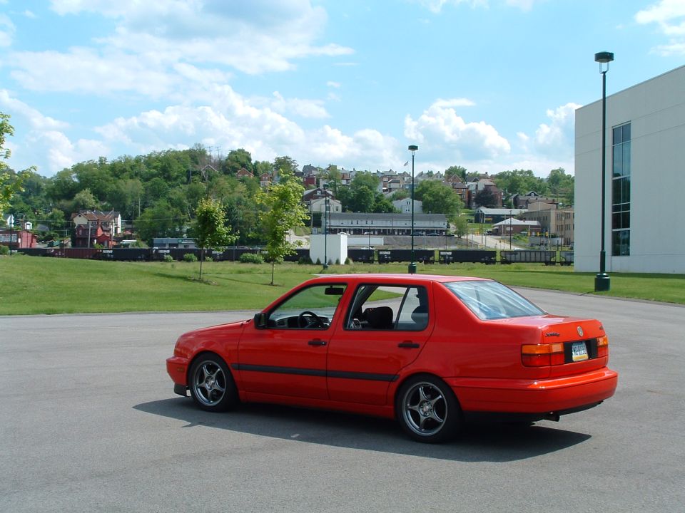 Red 1994 Volkswagen Jetta sedan, rear 3/4 view