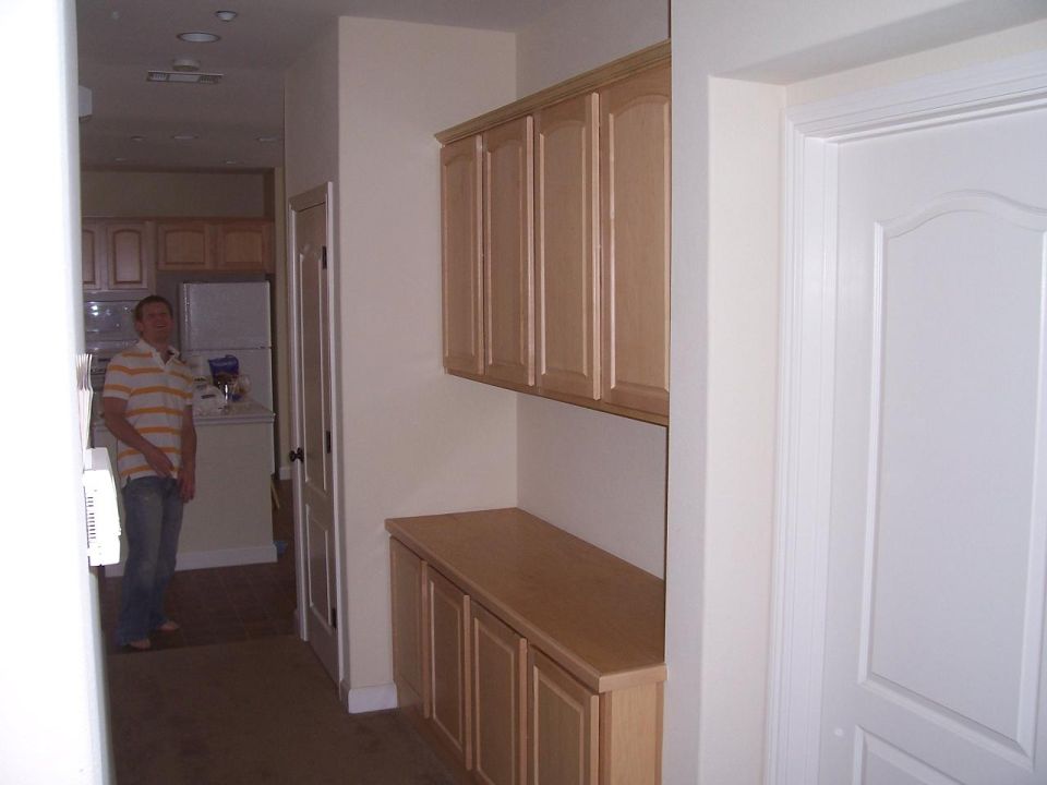 hallway and cabinets looking into kitchen and kenneth