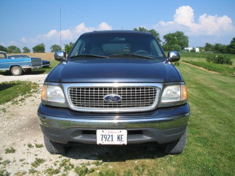1999 Ford Expedition - Front view of a 1999 Ford Expedition parked in a grassy area with another vehicle in the background.
