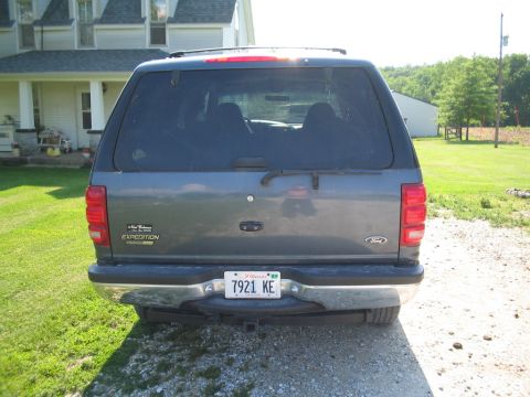 1999 Ford Expedition - The rear of a Ford Expedition is shown parked in front of a house on a sunny day.