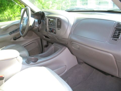 1999 Ford Expedition - The interior of a 1998 Ford Expedition shows a gray dashboard, steering wheel, and center console.