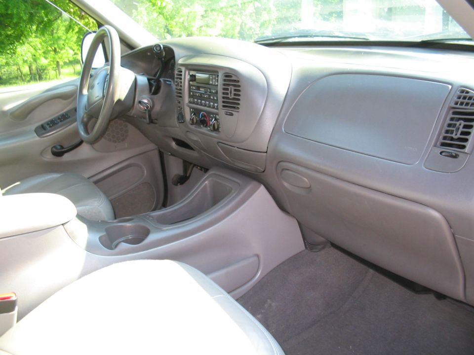 Gray interior of a 1998 Ford Expedition with a light-colored dashboard and seats