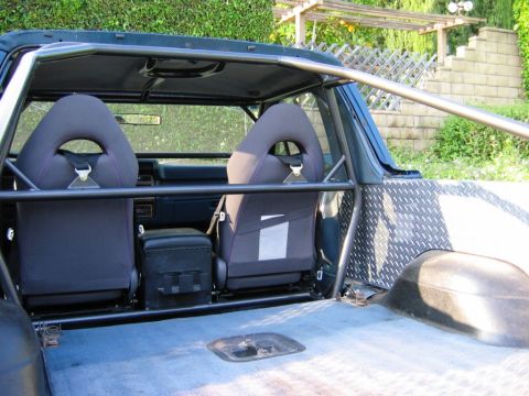 1985 Ford Bronco - The interior of this SUV shows racing seats and a prominent roll cage, suggesting modifications beyond its original model year.