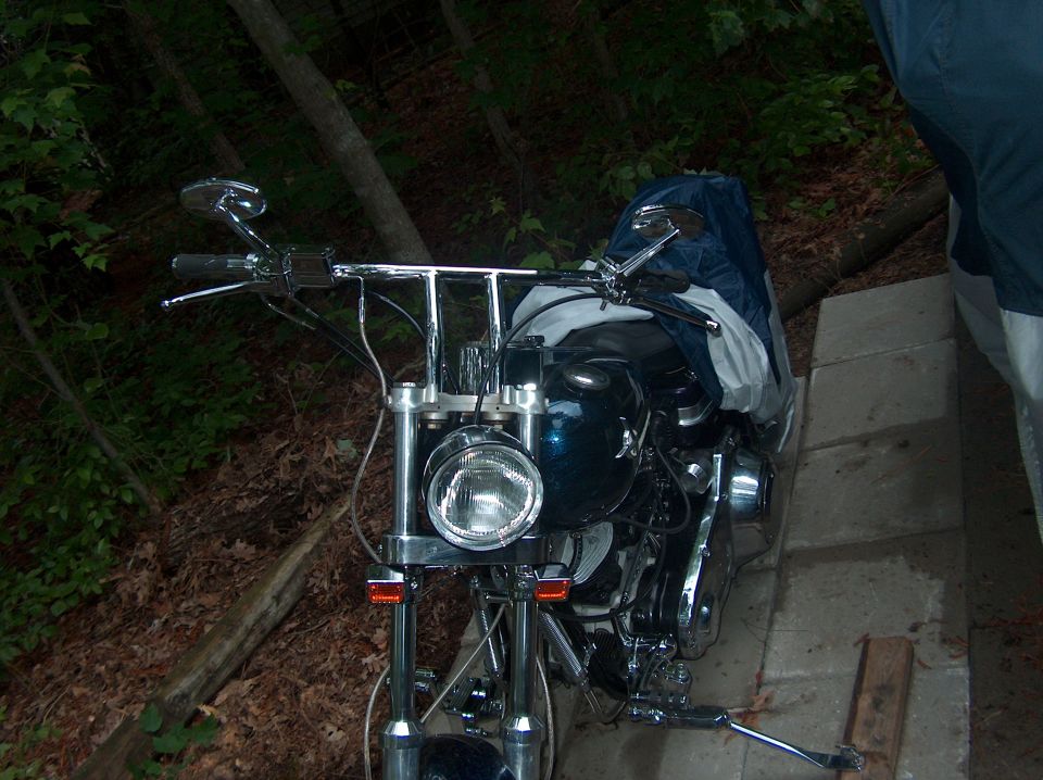 Motorcycle parked outdoors with trees in background