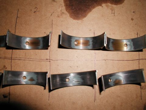 1992 Ford Taurus - Engine rod bearings show signs of wear, with markings indicating their position.