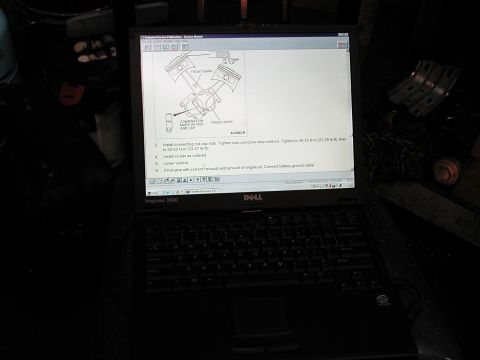 1992 Ford Taurus - Laptop displays a technical service manual page with a diagram of engine components and repair steps.