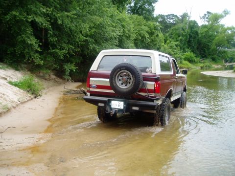 1990 Ford Bronco - This 1990 Ford Bronco navigates a shallow stream on a sunny day.