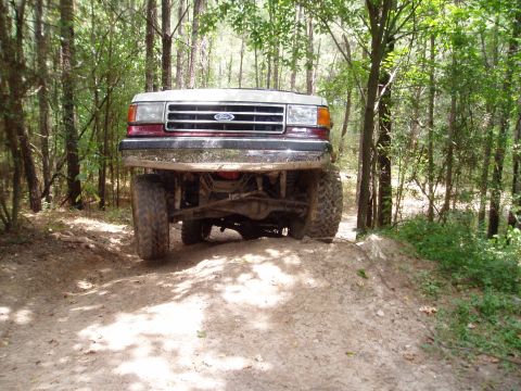 1990 Ford Bronco - This 1990 Ford Bronco navigates a wooded dirt path, its off-road capabilities.
