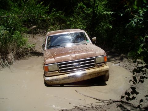 1990 Ford Bronco - This 1990 Ford Bronco is navigating a muddy trail.