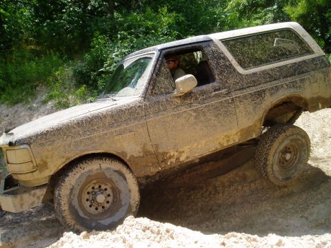1990 Ford Bronco - This 1990 Ford Bronco navigates a muddy off-road trail.