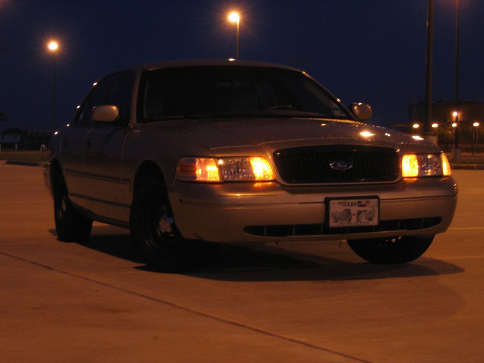 2000 Ford Crown Victoria parked at night, front view, Texas license plate visible