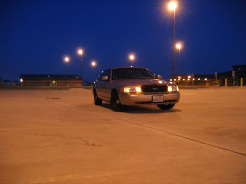 2000 Ford Crown Victoria - A 2000 Ford Crown Victoria is parked in an empty lot at dusk.