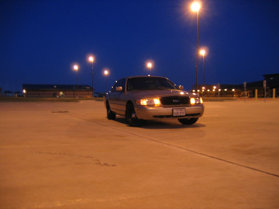 2000 Ford Crown Victoria parked at night under streetlights
