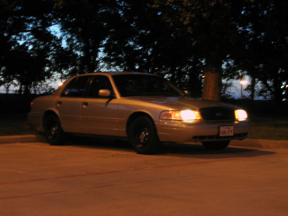 Tan 2000 Ford Crown Victoria parked at night