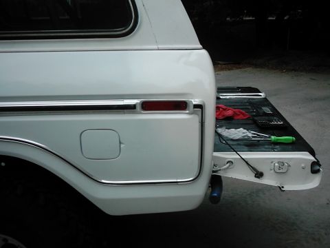 1978 Ford Bronco - Tailgate of a white 1978 Ford Bronco, with tools laid out on the bed.