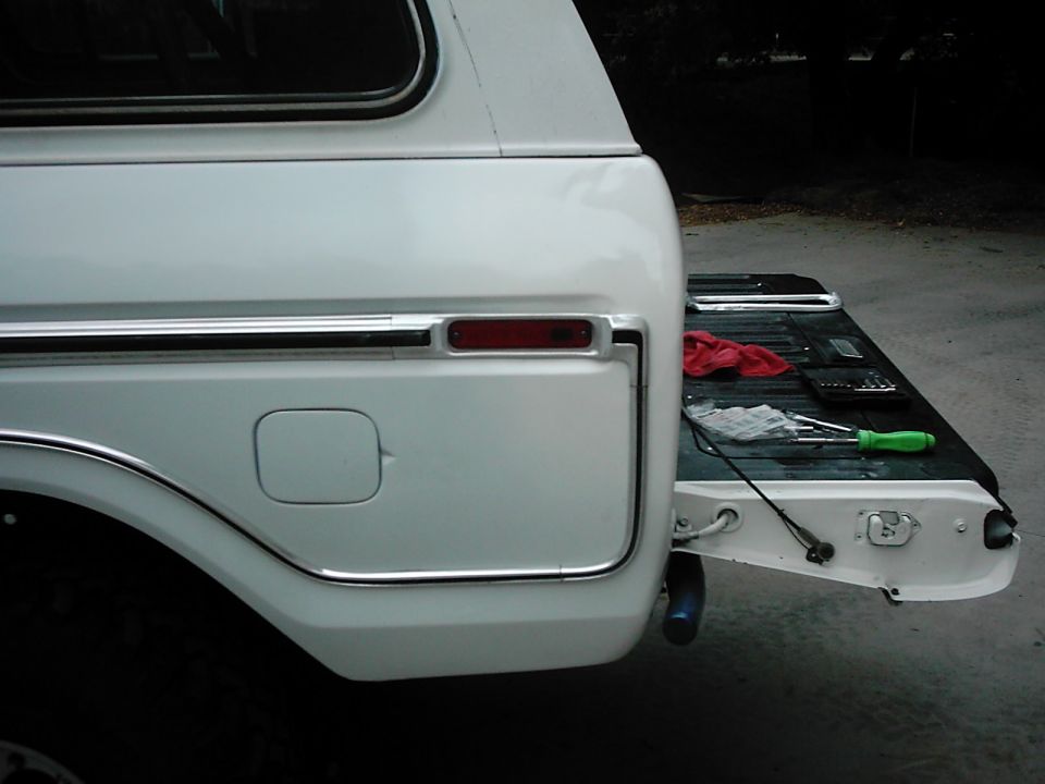 White 1978 Ford Bronco tailgate with tools on the bed