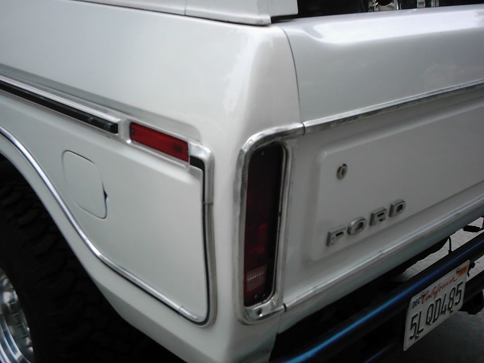 Rear quarter panel of a white 1978 Ford Bronco showing taillight and 'FORD' badging