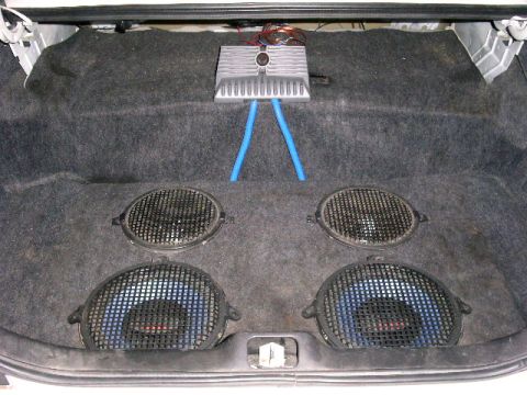 2001 Ford Crown Victoria - The trunk of a car is fitted with aftermarket audio equipment, including subwoofers and an amplifier.