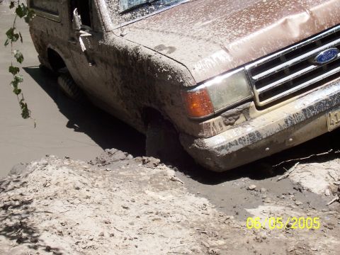1987 Ford Bronco - This 1987 Ford Bronco is stuck in a mud pit, with the front passenger side wheel submerged.