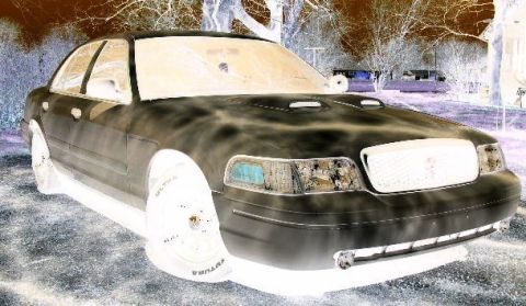 2001 Ford Crown Victoria - This 2001 Ford Crown Victoria is shown in a three-quarter front view with a prominent grille and hood scoops.