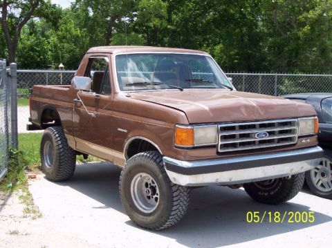 1987 Ford Bronco - This lifted 1987 Ford Bronco features a classic brown paint job and aggressive off-road tires.
