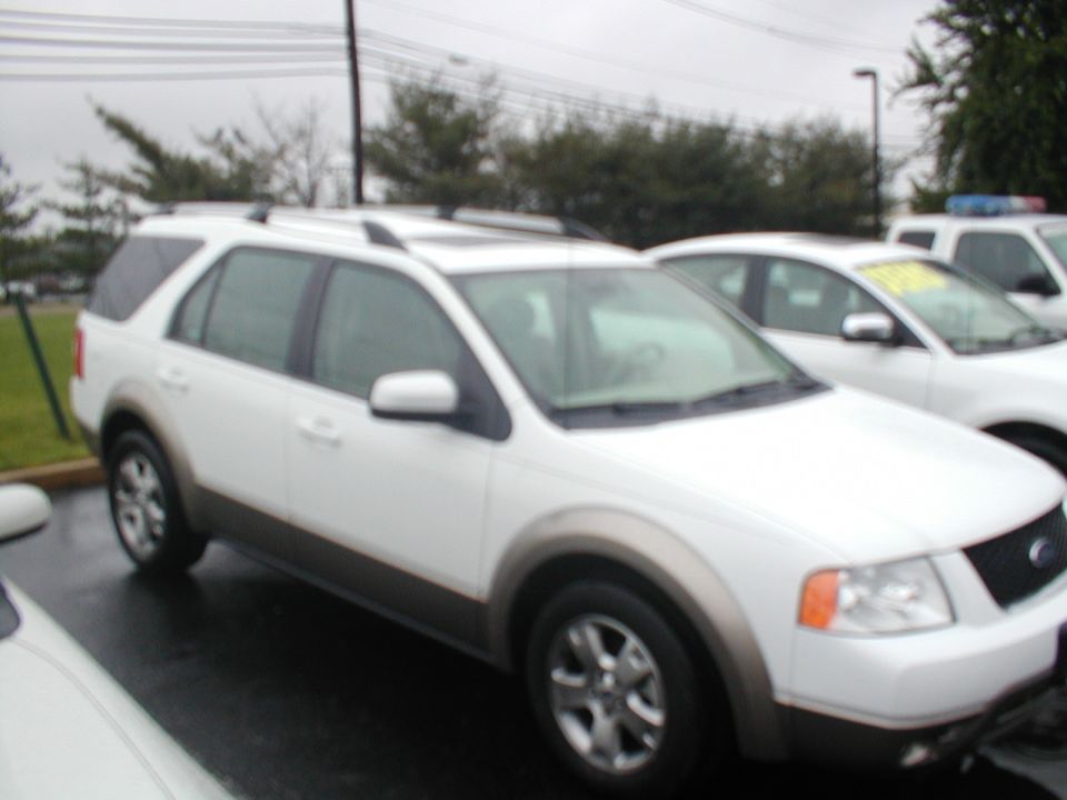 White SUV parked next to other cars. It has a two-tone paint job with a gray lower body