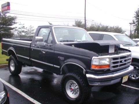 1979 Ford Bronco - This Ford F-250 pickup truck is parked outside with its hood open, revealing the engine compartment.
