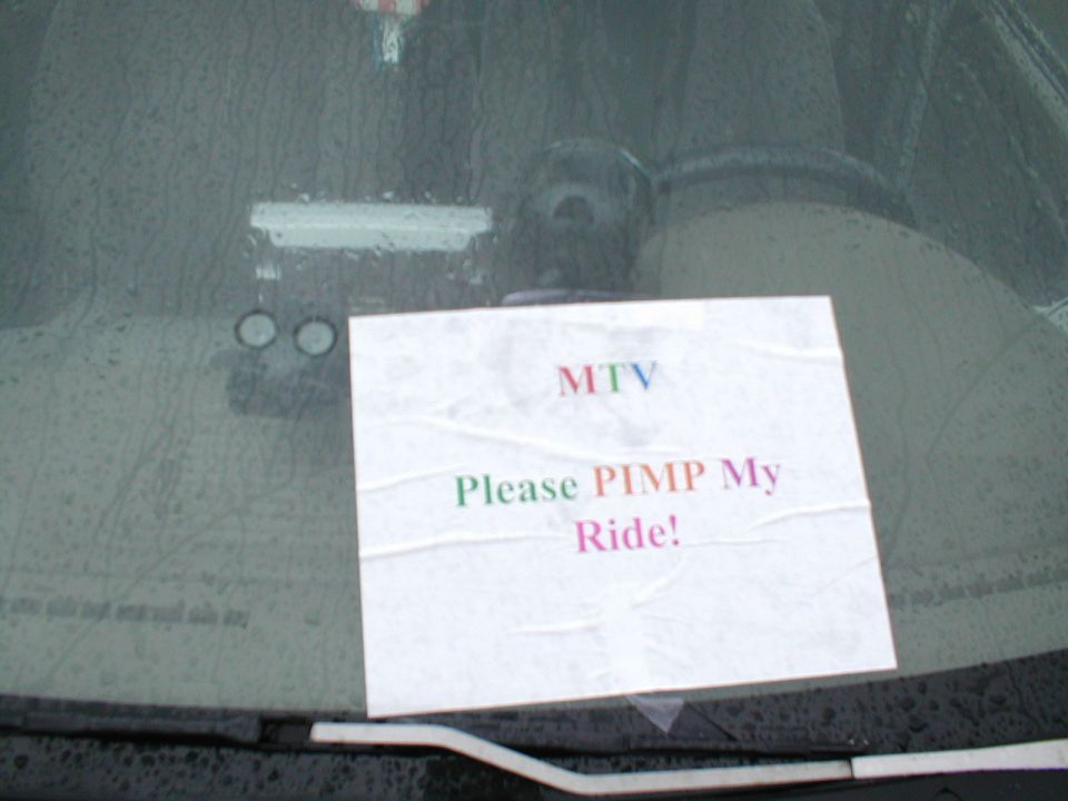 Paper sign on a wet windshield reads "MTV Please PIMP My Ride!"