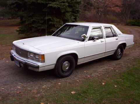 1991 Ford LTD Crown Victoria - This 1991 Ford Crown Victoria LTD is seen from a three-quarter front perspective, parked outdoors.