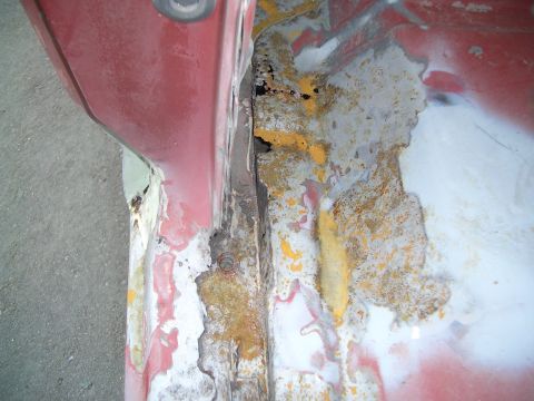 1981 Ford Bronco - This image shows extensive rust damage and corrosion on a vehicle's metal panel, indicating a need for repair.