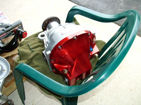 2003 Ford Mustang - Differential housing sits on a green chair, with a socket set and other parts in the background.