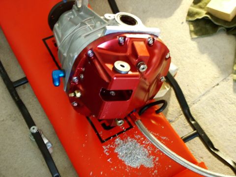 2003 Ford Mustang - A close-up view of a red and silver automotive differential part.