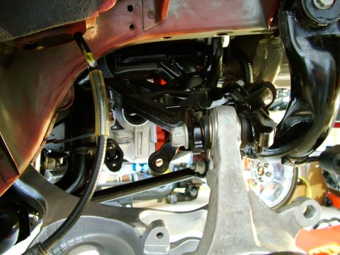 2003 Ford Mustang - Close-up view of the front suspension components, including control arms and steering knuckle.